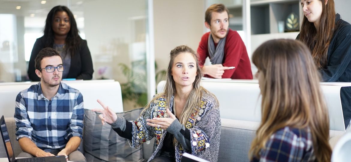 Woman in Team Meeting Discussing Work