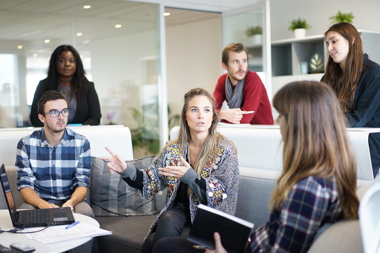 Woman in Team Meeting Discussing Work