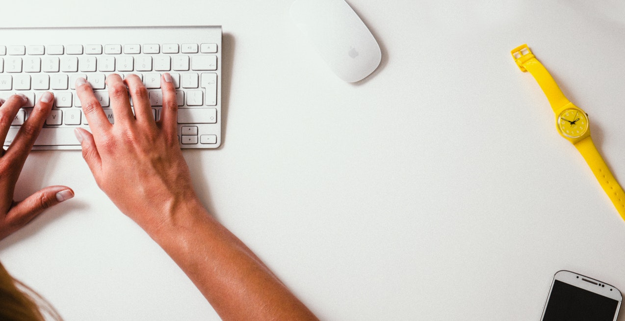 Woman typing on keyboard at a desk