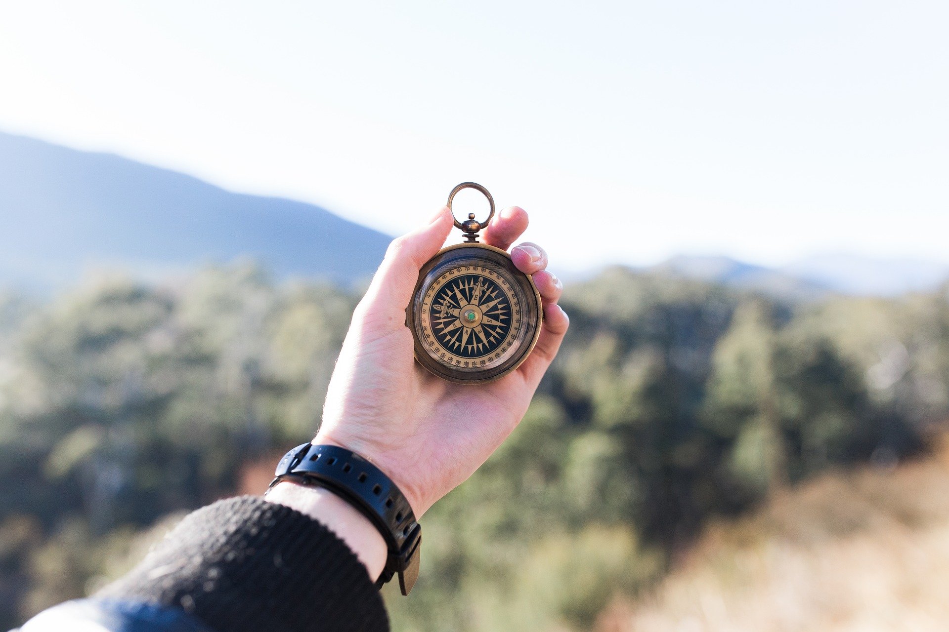 Person holding Compass Person holding Compass