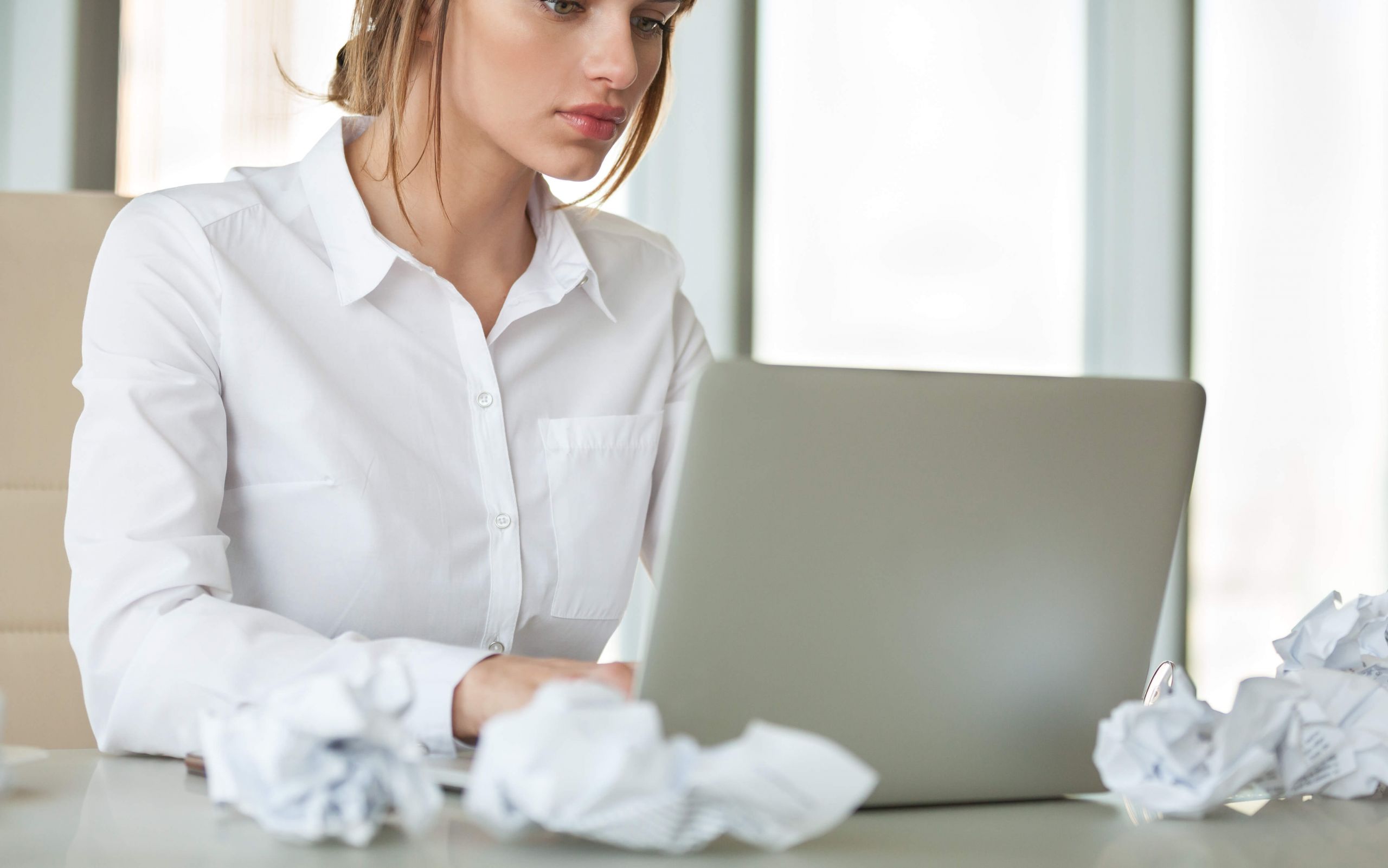 woman using macbook pro at desk