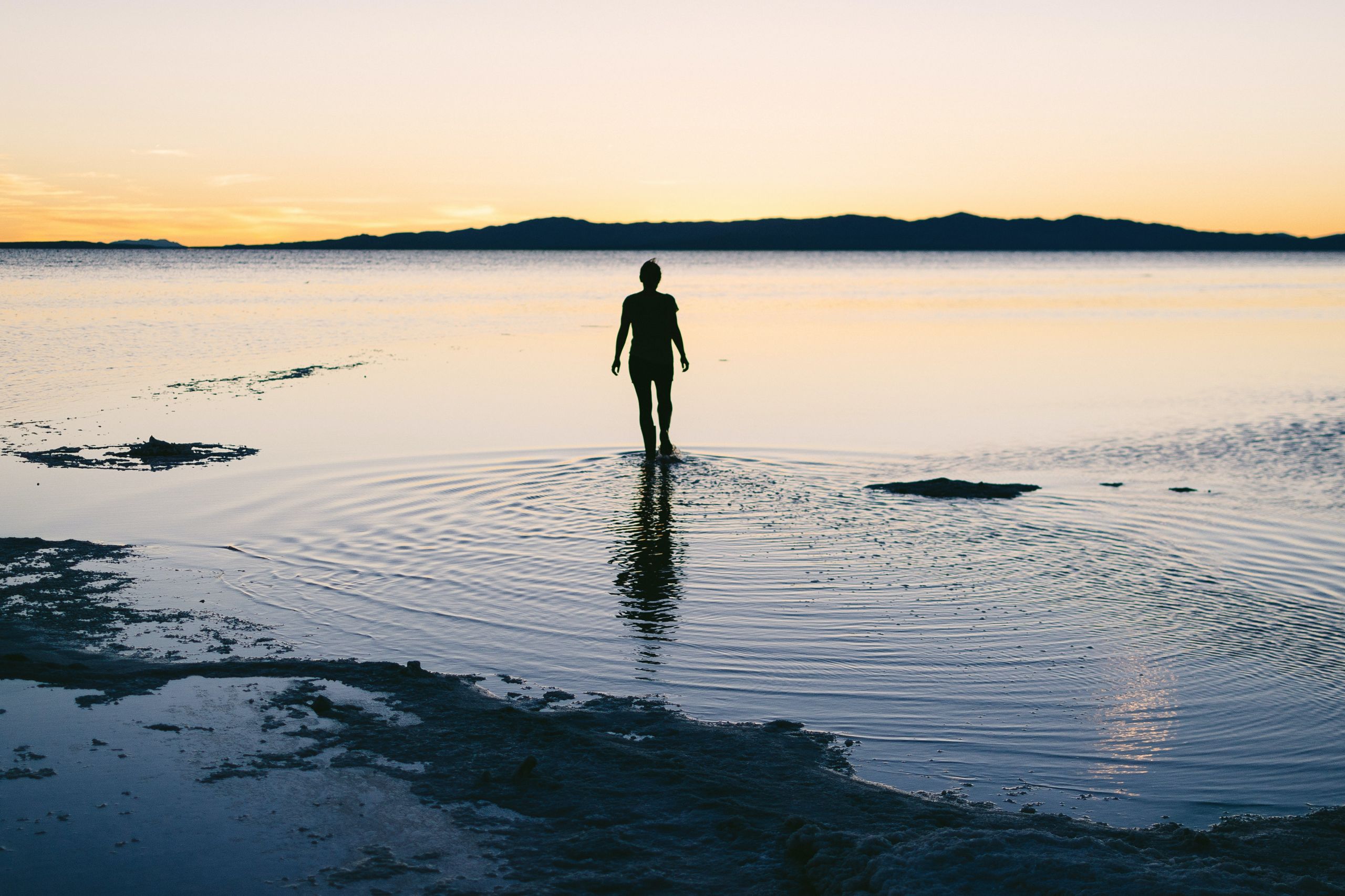 teen standing in lake water