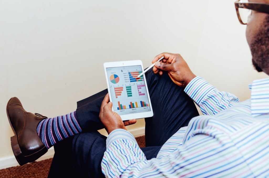 Man looking at charts on tablet