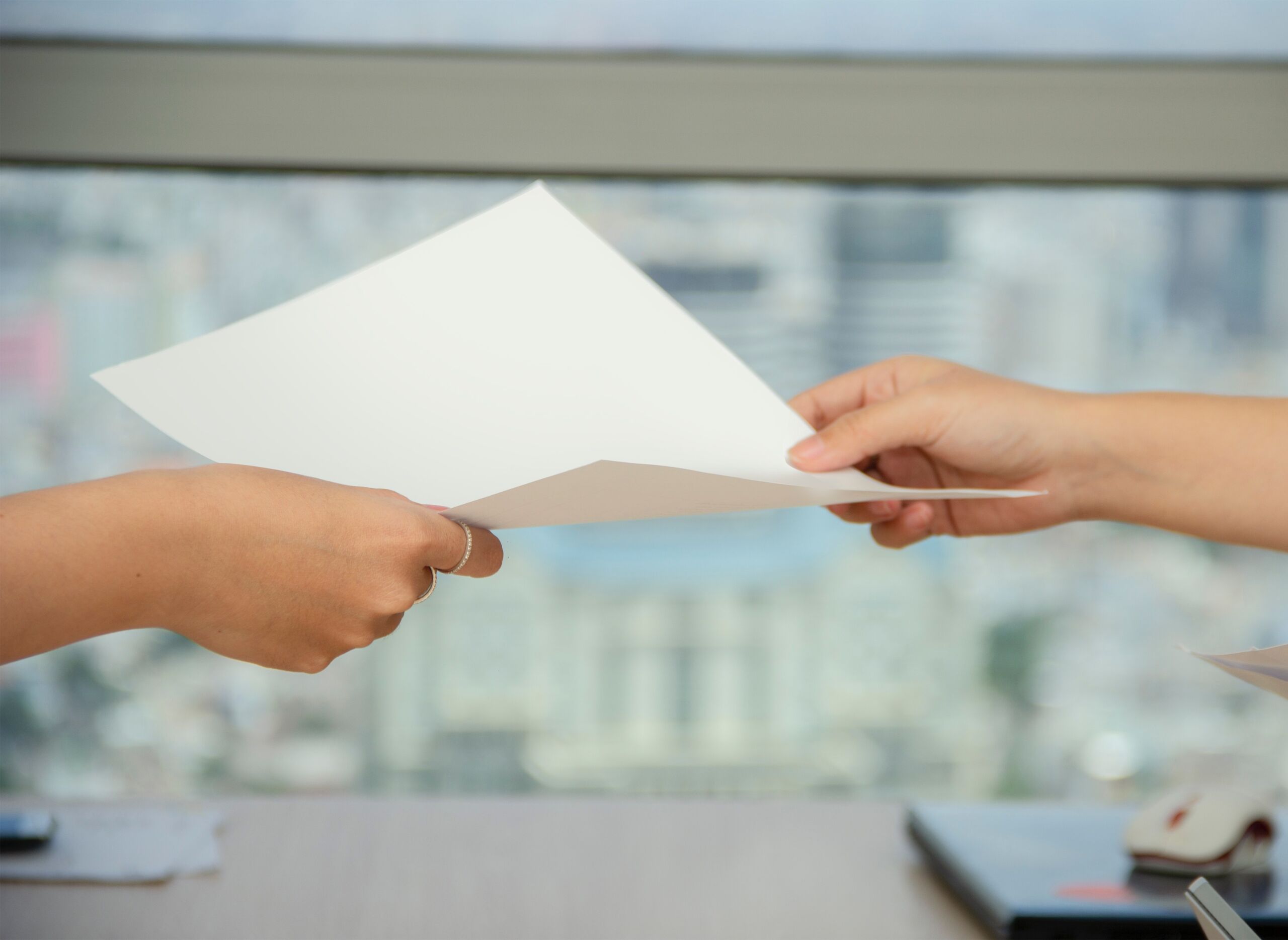 Person passing document to another