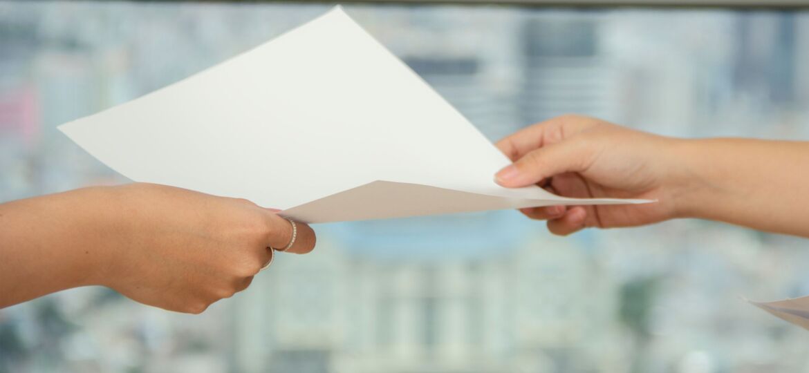 Person passing document to another